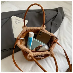 Internal view of a brown suede bucket bag with shearling trim and large capacity