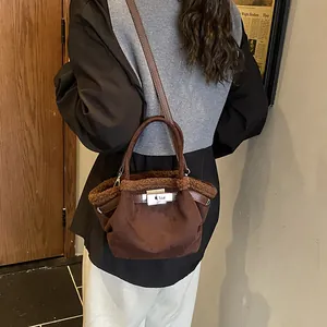 Deep brown plush bucket bag with leather strap and metal clasp for winter autumn