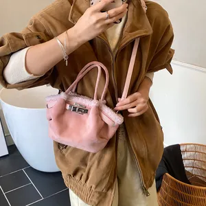 Pink matte leather bucket bag with fluffy faux fur trim and silver lock closure