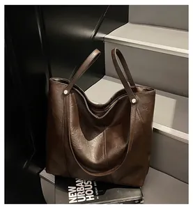 Detailed view of dark brown tote bag with vintage texture on architectural stairs