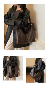 Detailed close-up of dark brown tote bag showing pebbled leather texture and silver rivets