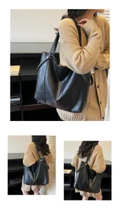 Detailed view of black faux leather tote bag with vertical stitching and silver buckles