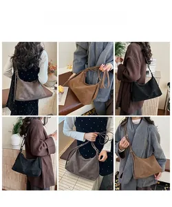 Detail view of large faux suede hobo bags in black, dark brown, and caramel colors
