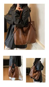 Detail view of large dark brown tote bag showing smooth PU leather texture and metal rivets