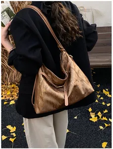 Detailed back view of a large brown retro hobo bag showing texture and slouchy drape