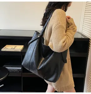 Detailed view of black vintage PU leather tote bag with subtle pleated texture