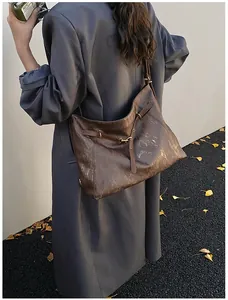 Detail of vintage brown tote bag texture and leather strap with metallic buckle