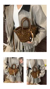Detail of leopard print bucket bag with leather strap and decorative beaded tassels