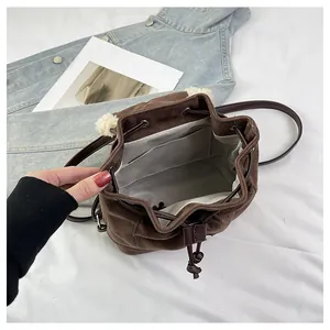 Interior detail of mini plush bucket bag showing lining and internal storage pocket