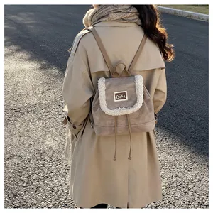 Detail of khaki plush-trimmed mini backpack featuring faux shearling edge and BEAR patch