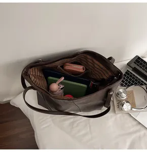 Interior view of large brown tote bag showing spacious compartments and storage capacity