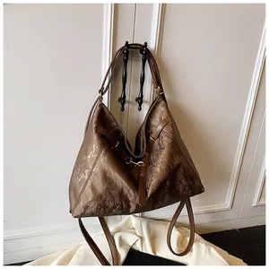 Close-up of deep brown metallic texture and vertical silk pattern on large tote bag