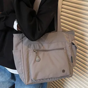Minimalist grey large capacity nylon tote bag with wide strap for casual daily use