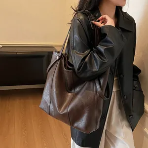 Minimalist large brown leather tote bag for women showing spacious daily commute design