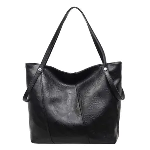 Minimalist large black PU leather tote bag with crinkled texture and silver metal rivets