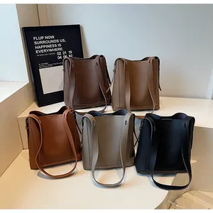 Detailed view of large bucket bags in five colors with premium pebble leather texture