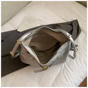 Macro shot of silver metallic tote bag interior showing textile lining and zipper pocket
