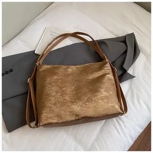 Detail of bronze textured metallic tote bag showing premium embossed leather and straps