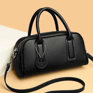 Classic black litchi pattern leather Boston bag with handles and a smiley face charm