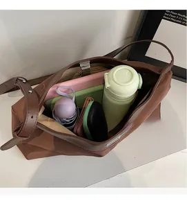 Spacious brown tote bag interior showing capacity for tablet, umbrella, and daily items