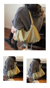 Detail view of olive green nylon hobo bag featuring silver buckle and adjustable strap
