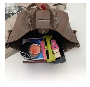 Spacious interior of the brown lychee pattern tote bag with various personal items