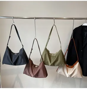 Detailed display of crescent hobo shoulder bags in black, tan, olive, and beige colors