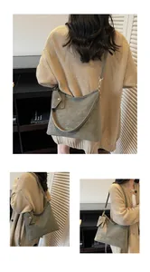 Detail of olive green vintage shoulder bag with adjustable strap and small card holder charm