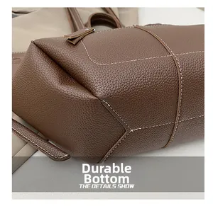 Detailed close-up of a brown litchi leather bag showing the wear-resistant flat bottom