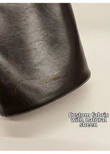 Detail of custom leather fabric with natural luster and golden embossed fashion text