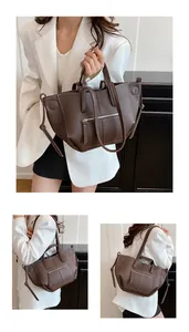 Detail of dark brown pebble leather tote bag with white stitching and drawstring accents