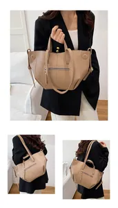Detail of beige lychee pattern tote bag with dual handles and metal zipper pocket