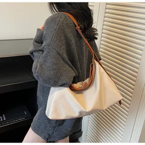 Detail of minimalist beige tote bag with brown straps and spacious interior for daily use