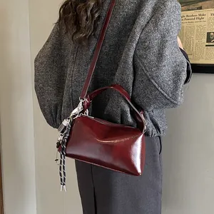 Retro burgundy large capacity leather crossbody bag for women with woven charm detail