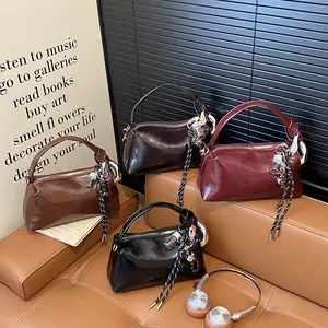 Glossy leather satchel bags in four colors with knot handles and stylish charms