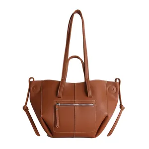 Brown lychee leather tote bag with contrast stitching and versatile handle design