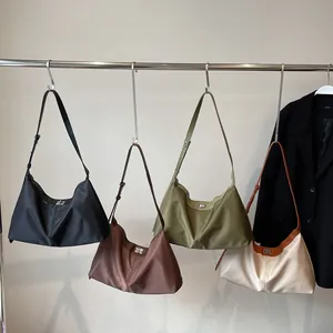 Minimalist nylon hobo tote bag in four colors with adjustable shoulder straps and metal lock