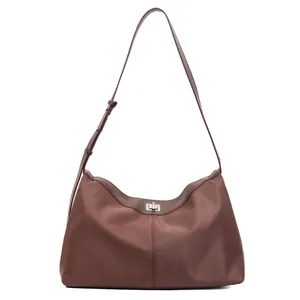Brown nylon tote bag with silver metal twist lock and adjustable shoulder strap