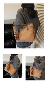 Detail of embossed brown tote bag with plush bear charm and premium faux leather texture