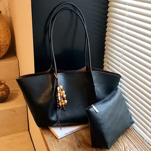 Vintage black leather tote bag set with inner pouch and wooden bead tassel for daily use