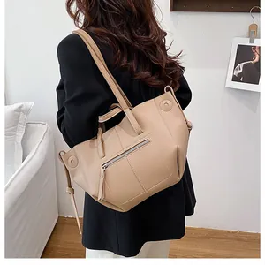 Side view of beige lychee pattern leather tote bag showing large capacity for daily commute