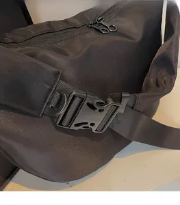 Detail of adjustable black woven shoulder strap with durable plastic buckle for bag