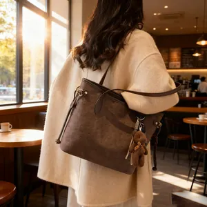 Large dark brown embossed tote bag with cartoon bear patterns and cute bag pendant