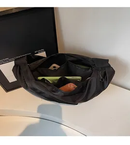 Internal view of black oxford fabric crossbody bag showing spacious compartments and storage