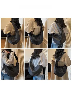 Multi-angle view of large black oxford crossbody bag on model with adjustable strap