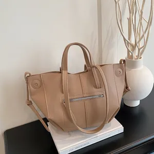 Khaki lychee leather tote bag with wing design and metal zipper pocket for commuting