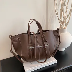 Large dark brown lychee leather tote bag with contrast stitching and multi-strap design