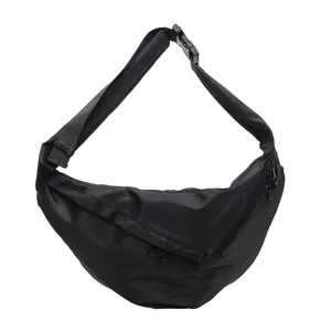 Minimalist black nylon half-moon crossbody bag with multiple zip pockets and adjustable strap
