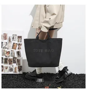 Fashionable black large capacity tote bag shown with model for casual style