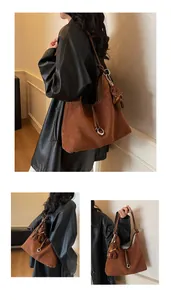 Detail of caramel suede tote bag featuring a metal buckle and brown plush bear charm